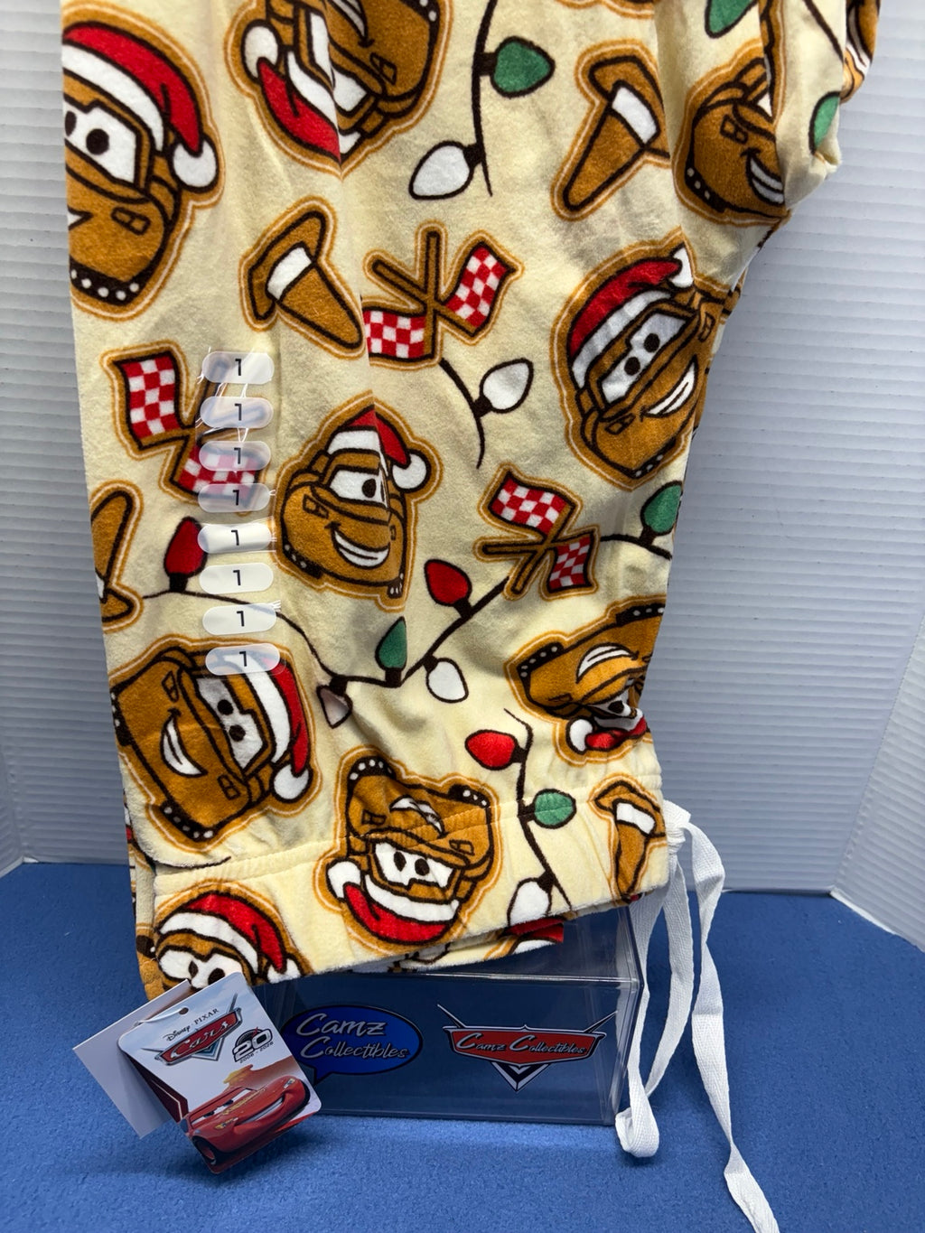 Cream Disney Pixar Cars holiday pajama pants with Mater, Lightning McQueen, Santa hats and Christmas lights