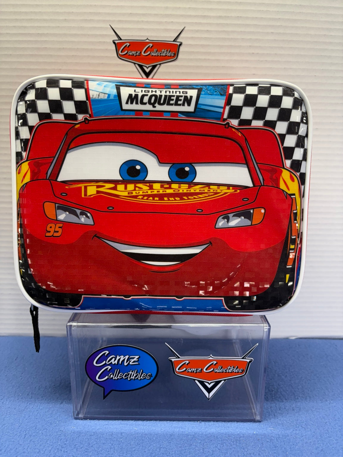 Disney Pixar Cars Lightning McQueen lunch box with checkered racing background and white trim