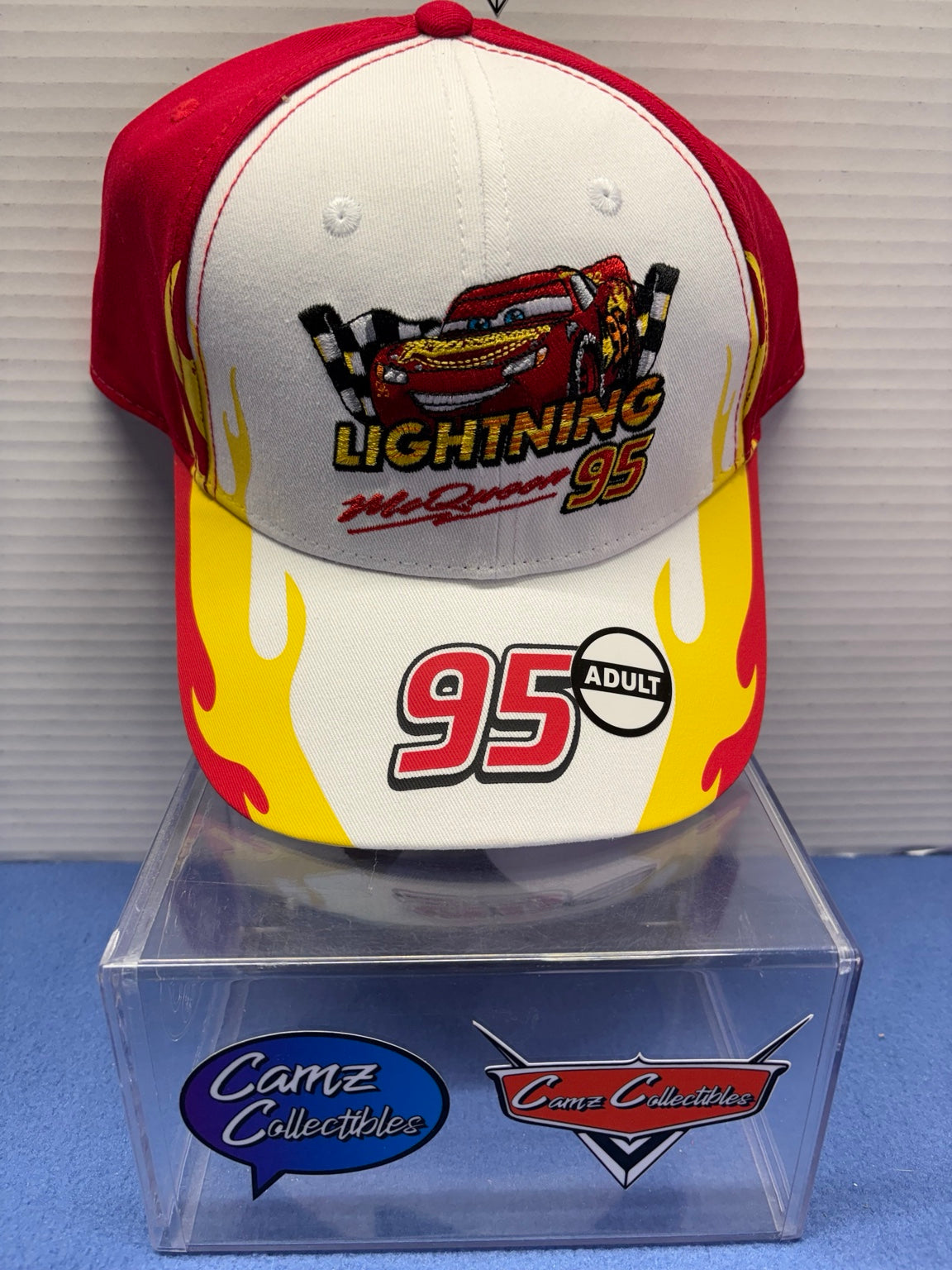 Disney Pixar Cars adult Lightning McQueen 95 hat with white front, red panels and yellow flame graphics