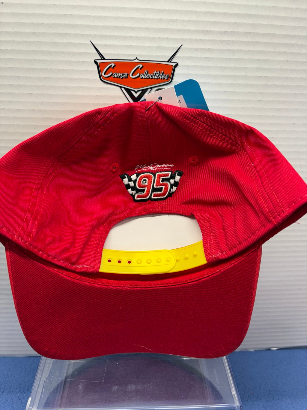 Back of red Lightning McQueen adult hat with embroidered 95 and yellow adjustable snap closure