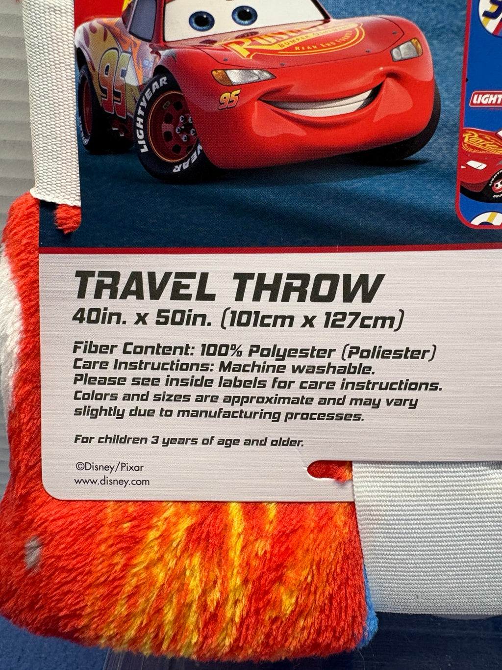 Travel throw label showing 40 by 50 inches, 100 percent polyester, machine washable, ages 3 and older